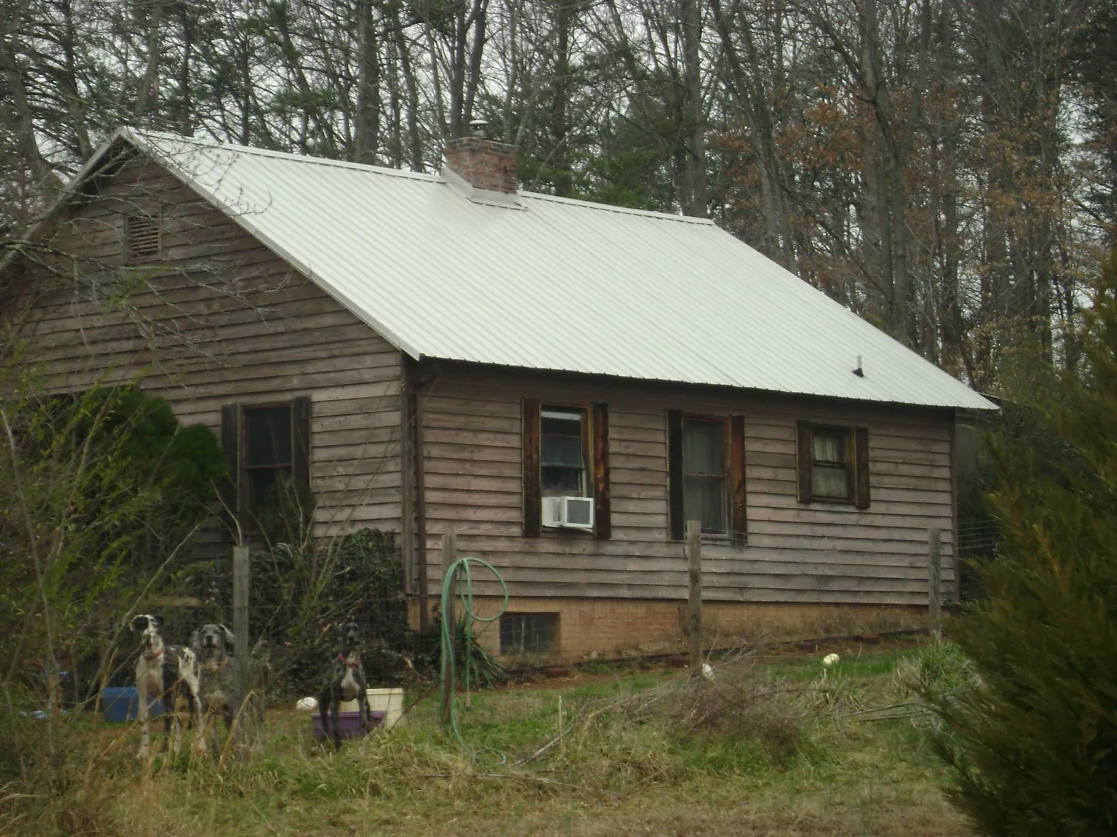 White metal roof on an old wood sided farmhouse, from a Metal Roof Installation job in Hartleton